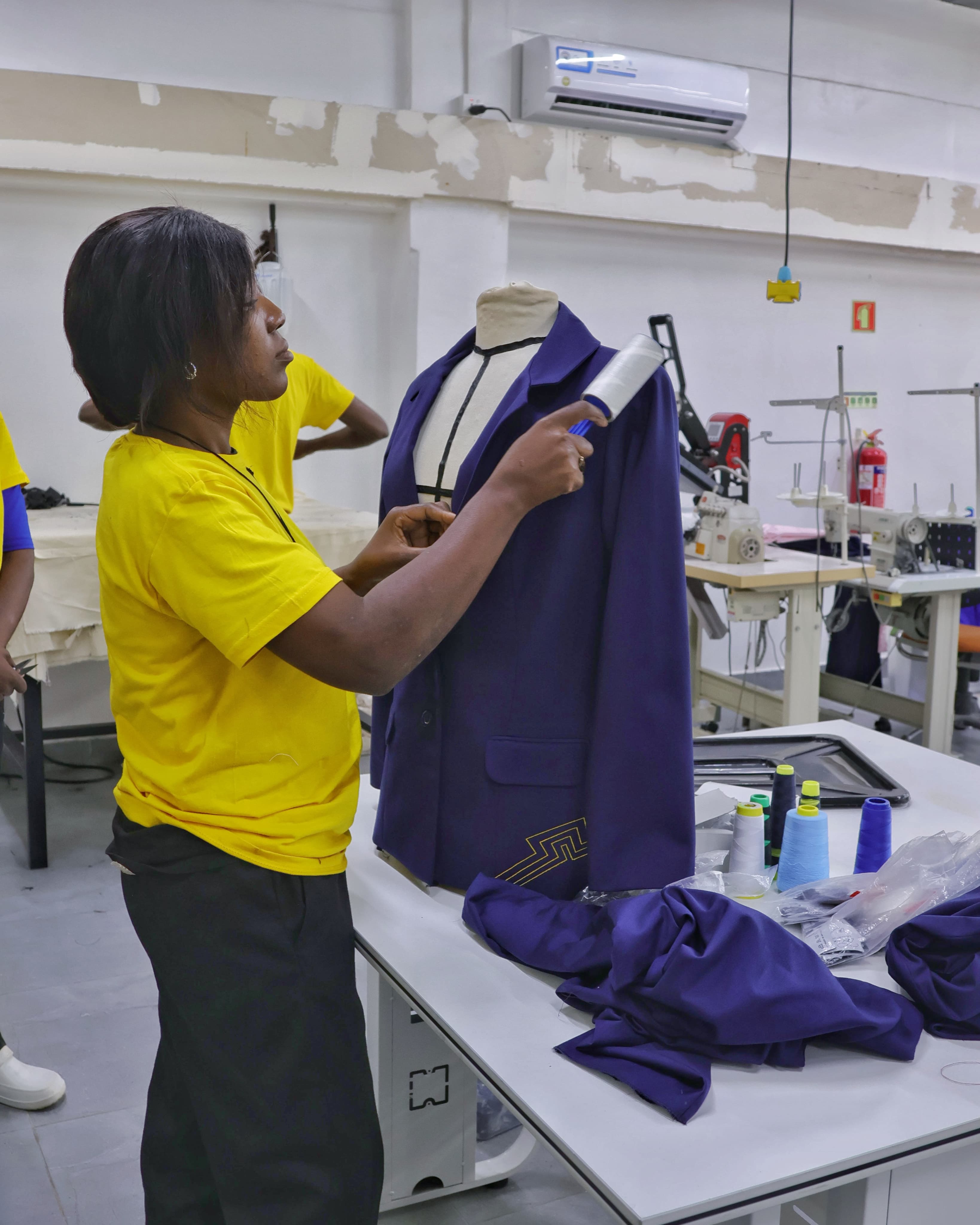 A seamstress preparing a piece of corporate clothing